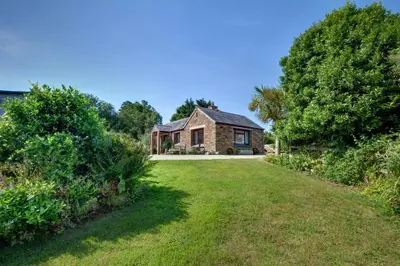 a house with a large yard in front of it at 1 Bed in Wadebridge oc-p00440 in Saint Issey