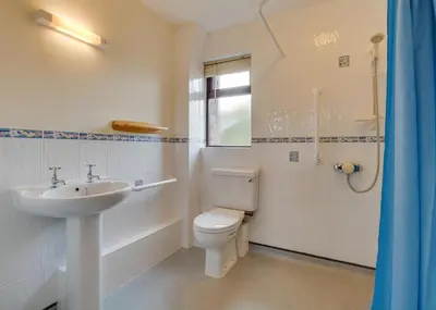 a bathroom with a white toilet and a sink at 1 Bed in Wadebridge oc-p00440 in Saint Issey