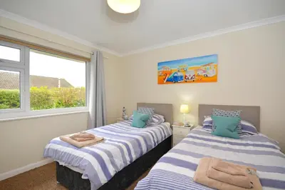 two beds in a room with a window at 2 Bed in Padstow oc-p00464 in St Merryn