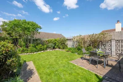 a garden with a table and chairs in a yard at 2 Bed in Padstow oc-p00464 in St Merryn
