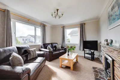 a living room with a couch and a television at 2 Bed in Padstow oc-p00464 in St Merryn
