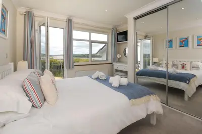 a bedroom with two beds and a large window at 3 Bed in Padstow oc-p00418 in Padstow