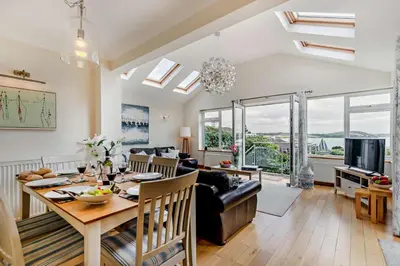 a living room with a dining table and a couch at 3 Bed in Padstow oc-p00418 in Padstow