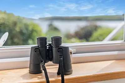 a pair of binoculars sitting on a table next to a window at 3 Bed in Padstow oc-p00418 in Padstow