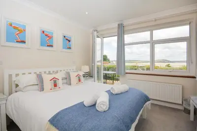 a bedroom with two beds and a window at 3 Bed in Padstow oc-p00418 in Padstow