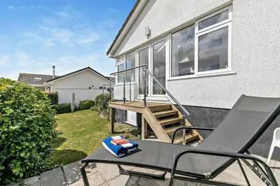 a patio with a chair and a stair case at 3 Bed in Padstow oc-p00418 in Padstow