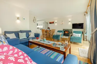 a living room with a blue couch and a table at 3 Bed in Padstow oc-p00435 in Padstow