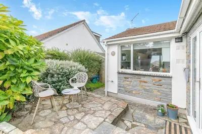 a garden with two chairs and a patio at 3 Bed in Padstow oc-p00435 in Padstow