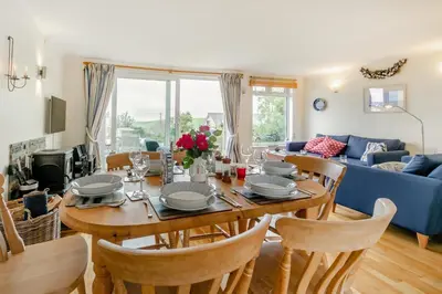 a dining room and living room with a table and chairs at 3 Bed in Padstow oc-p00435 in Padstow