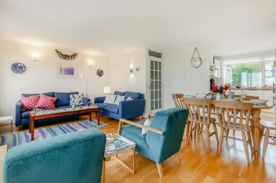 a living room with a blue couch and a table at 3 Bed in Padstow oc-p00435 in Padstow