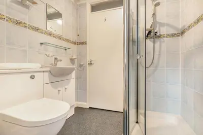 a bathroom with a toilet and a sink and a shower at 3 Bed in Padstow oc-p00435 in Padstow