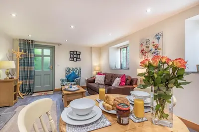 a living room with a table and a couch at 1 Bed in Bodmin oc-p00438 in Bodmin