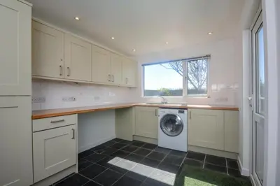 a laundry room with a washer and dryer in it at 4 Bed in Padstow oc-p00425 in St Merryn