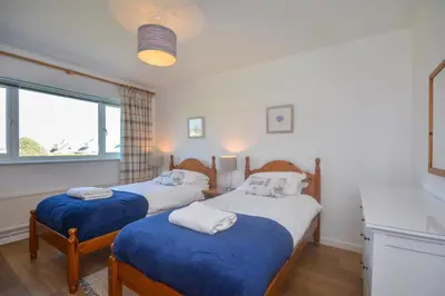 a bedroom with two beds and a window at 4 Bed in Padstow oc-p00425 in St Merryn