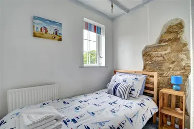 a bedroom with a bed and a window at 3 Bed in Newquay oc-p00484 in Newquay