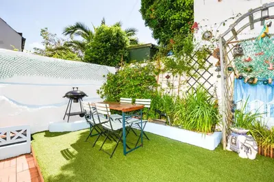 a small garden with a table and chairs and a grill at 3 Bed in Newquay oc-p00484 in Newquay