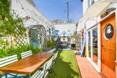 an outdoor patio with a wooden table and benches at 3 Bed in Newquay oc-p00484 in Newquay