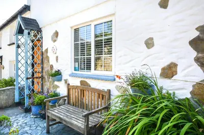 a wooden bench sitting in front of a building at 3 Bed in Newquay oc-p00484 in Newquay
