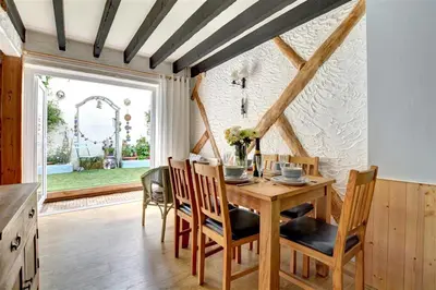 a dining room with a wooden table and chairs at 3 Bed in Newquay oc-p00484 in Newquay