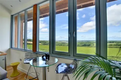 a room with a glass table and some windows at 3 Bed in Wadebridge oc-p00415 in Saint Issey
