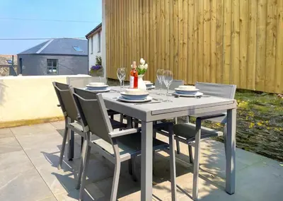 a white table with chairs and a cake on it at 2 Bed in Padstow oc-p00481 in Padstow