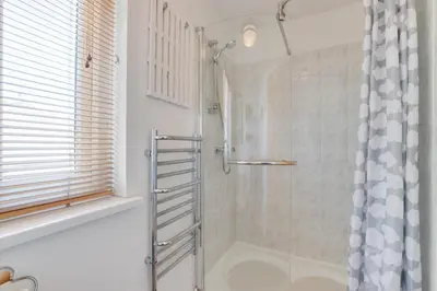a bathroom with a shower with a shower curtain at 2 Bed in Padstow oc-p00481 in Padstow