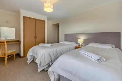 a hotel room with two beds and a desk at 2 Bed in Padstow oc-p00486 in St Merryn