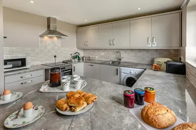 a kitchen with two plates of food on a counter at 2 Bed in Padstow oc-p00486 in St Merryn