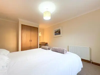 a bedroom with a white bed with two towels on it at 2 Bed in Padstow oc-p00486 in St Merryn