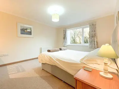 a bedroom with a bed and a lamp on a table at 2 Bed in Padstow oc-p00486 in St Merryn
