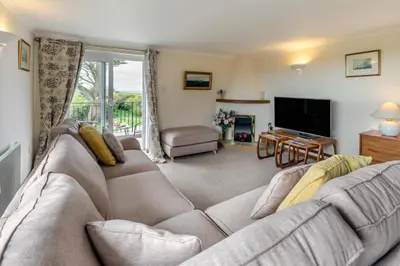 a living room with a couch and a television at 2 Bed in Padstow oc-p00486 in St Merryn