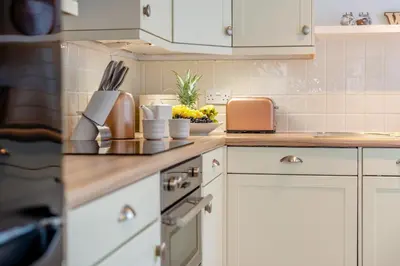 a kitchen with white cabinets and a counter top at 3 Bed in Padstow oc-p00455 in Padstow