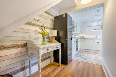 a kitchen with wooden walls and a table with flowers on it at 3 Bed in Padstow oc-p00455 in Padstow