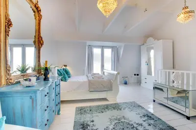 a bedroom with a bed with a mirror and a blue dresser at 3 Bed in St Ives oc-p00495 in St Ives