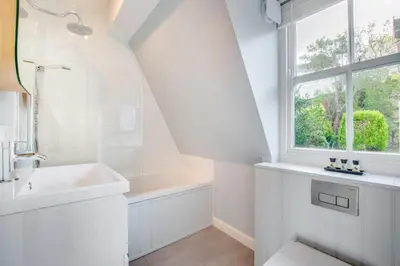 a white bathroom with a sink and a window at 3 Bed in St Ives oc-p00495 in St Ives