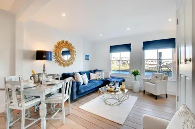 a living room with a blue couch and a table at 3 Bed in St Ives oc-p00495 in St Ives