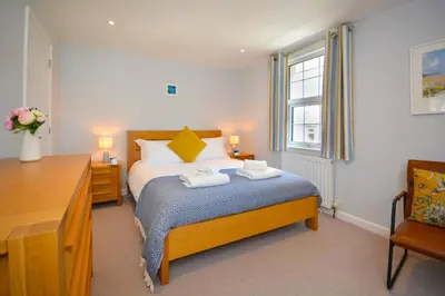 a bedroom with a bed with two towels on it at 3 Bed in Padstow oc-p00504 in Padstow