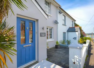 a house with a blue door on a street at 3 Bed in Padstow oc-p00504 in Padstow