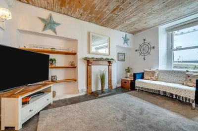 a living room with a large flat screen tv at 2 Bed in Padstow oc-p00505 in Padstow