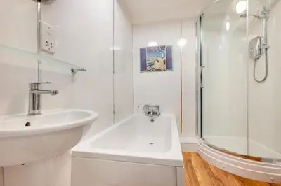 a white bathroom with a sink and a shower at 2 Bed in Padstow oc-p00505 in Padstow