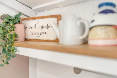 a shelf with a coffee mug and a picture at 2 Bed in Padstow oc-p00509 in Padstow