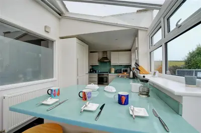 a blue table with utensils on it in a kitchen at 4 Bed in Padstow oc-p00528 in Padstow