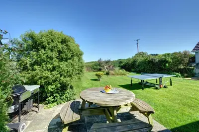 a picnic table and ping pong ball on a lawn at 4 Bed in Padstow oc-p00528 in Padstow