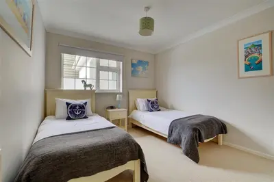 a bedroom with two beds and a window at 4 Bed in Padstow oc-p00528 in Padstow