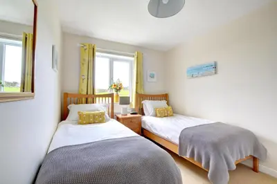 a bedroom with two beds and a window at 2 Bed in Padstow oc-p00531 in Padstow