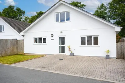 a white house with a fence at 3 Bed in St. Merryn oc-p00569 in St Merryn