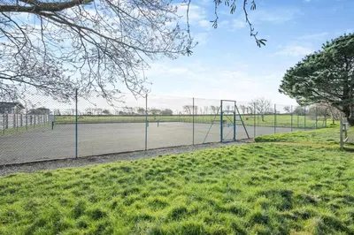 a tennis court with a net on a court at 3 Bed in St. Merryn oc-p00569 in St Merryn