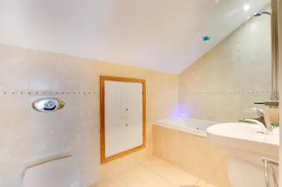 a bathroom with a sink and a tub and a mirror at 3 Bed in St. Merryn oc-p00569 in St Merryn