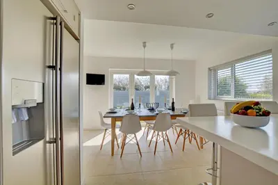 a kitchen and dining room with a table and chairs at 6 Bed in Constantine Bay oc-p00571 in St Merryn