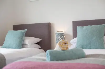 a stuffed animal sitting on top of two beds at 6 Bed in Constantine Bay oc-p00571 in St Merryn
